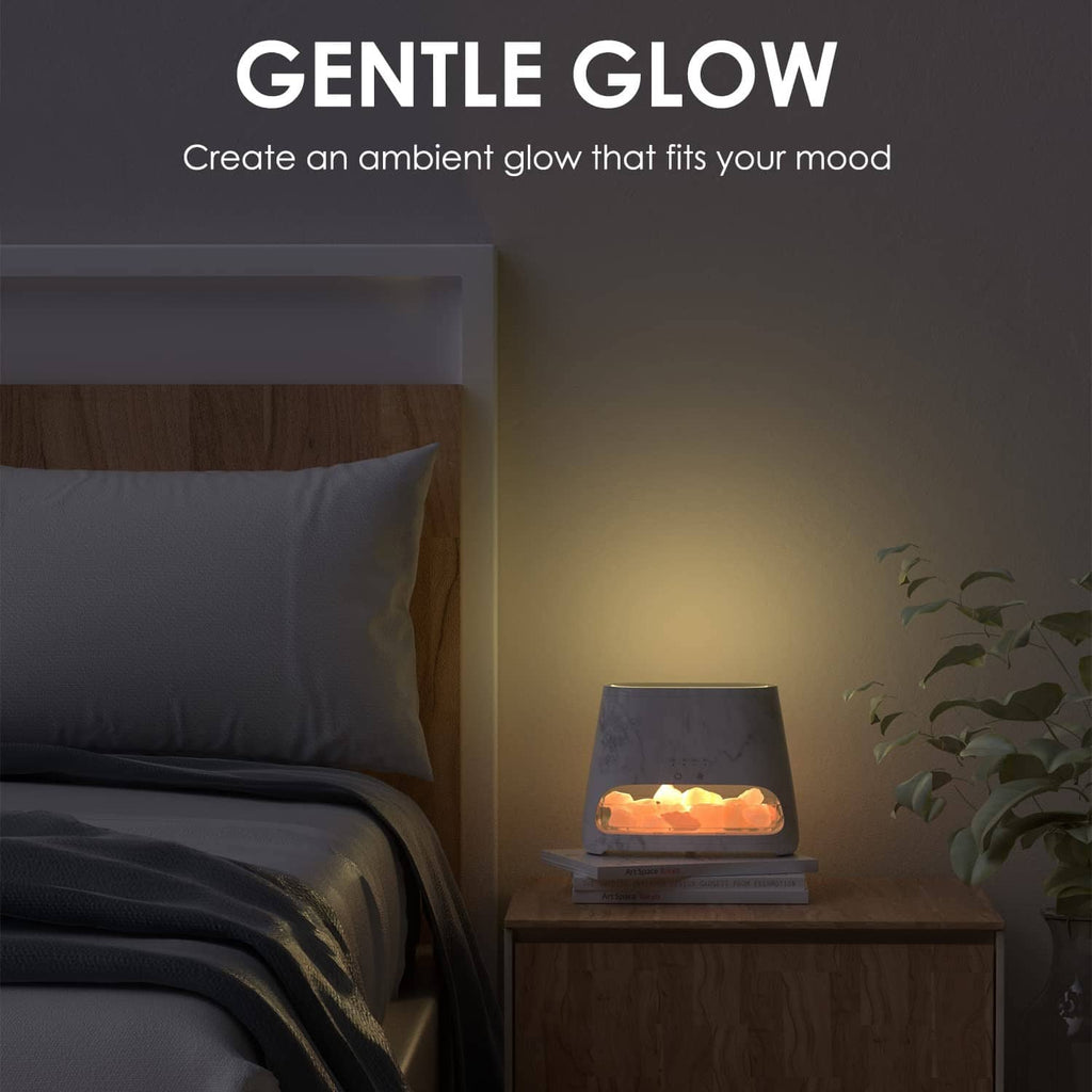 Small salt lamp diffuser with gentle warm glow on a side table