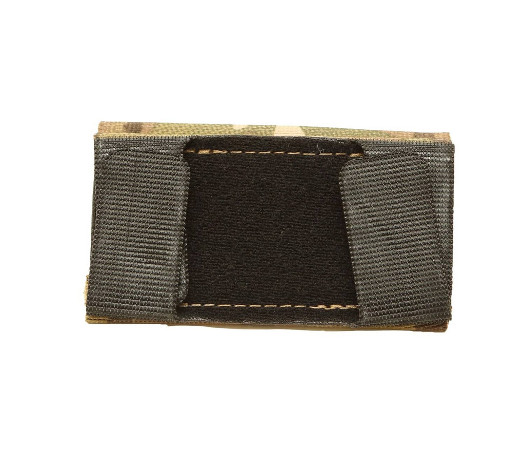 Elastic tourniquet pouch with black interior panel and black webbing side panels