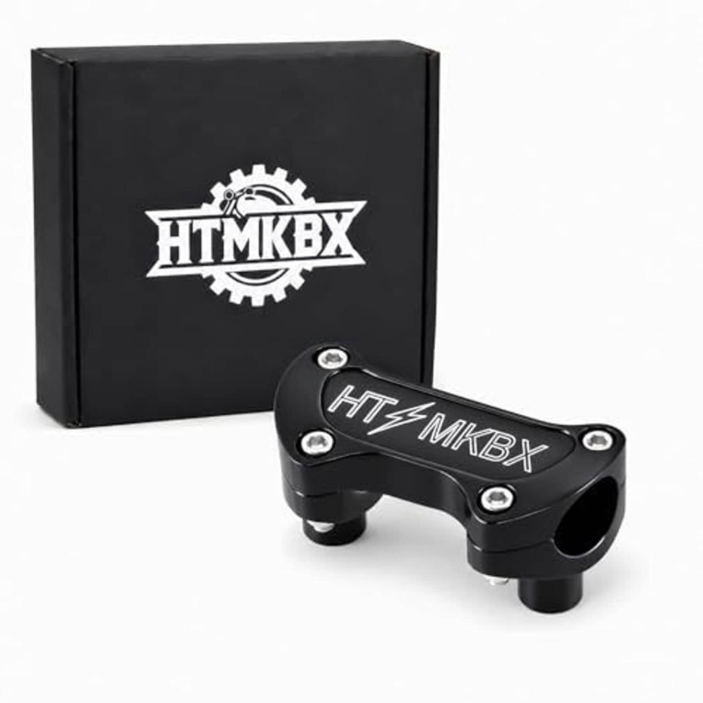 Black handlebar top clamp riser, riser blocks and side mounting bolts visible
