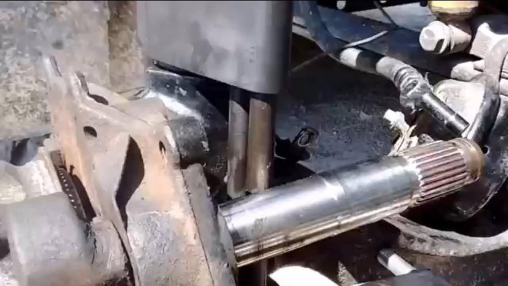 King pin press tool action on vehicle parts with spindle and metal linkage