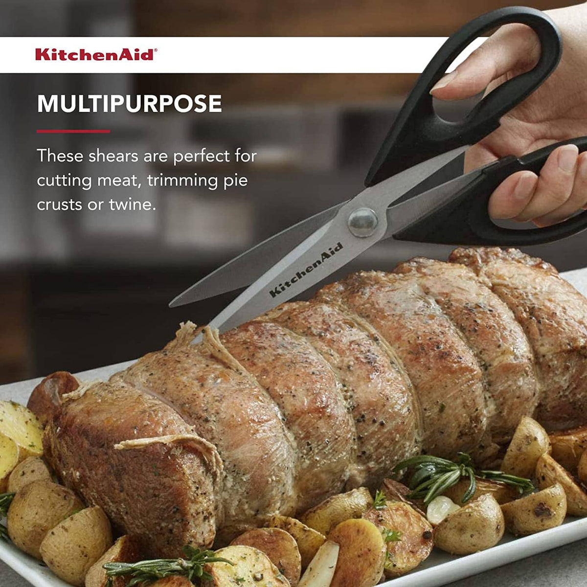 All-purpose kitchen shears with stainless blades and black loop handles on food prep