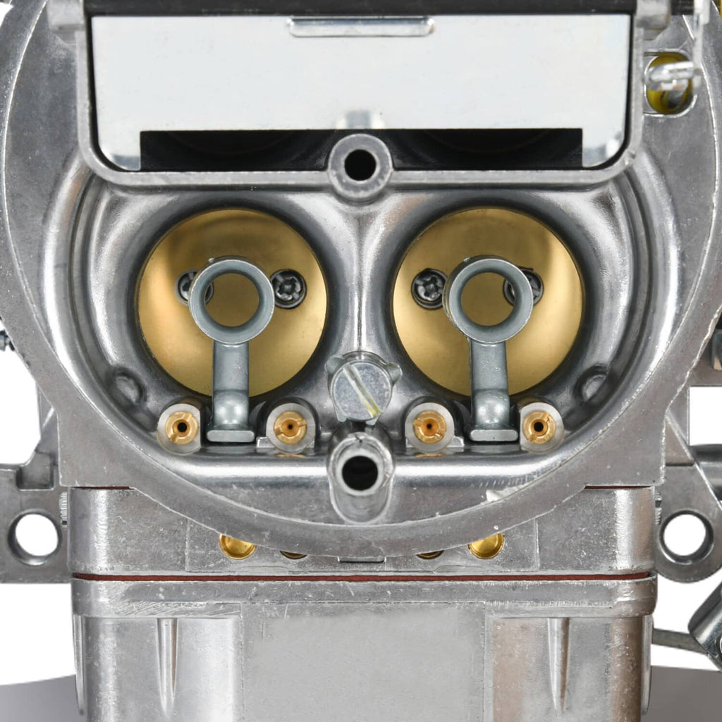Carburetor throttle bores with twin circular chambers and gold-toned interiors