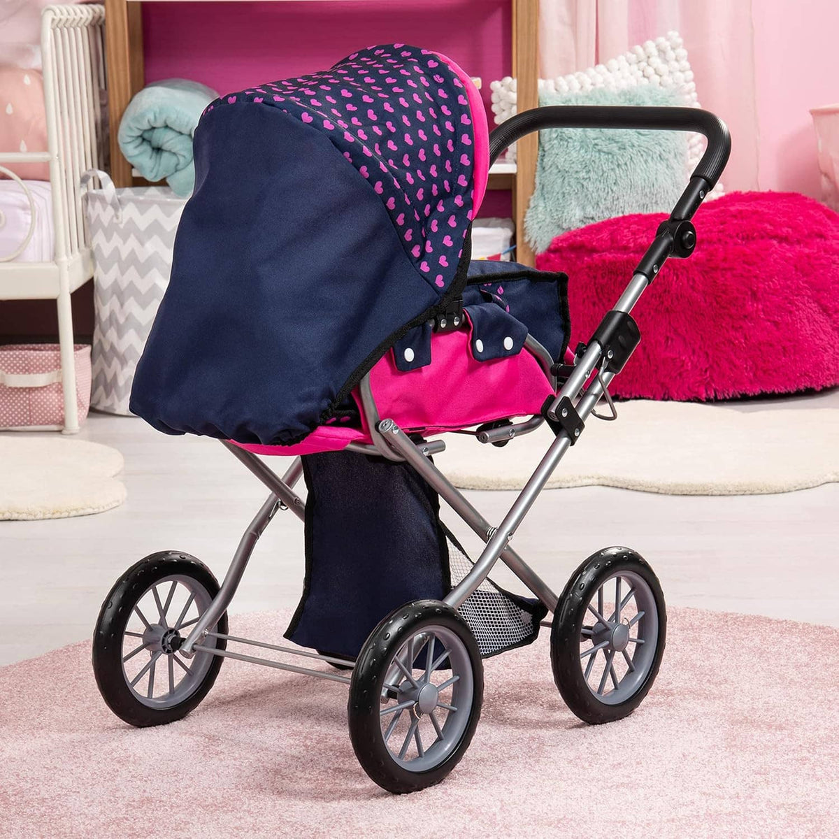 Navy and pink doll pram with heart print hood, basket, and four-spoke wheels