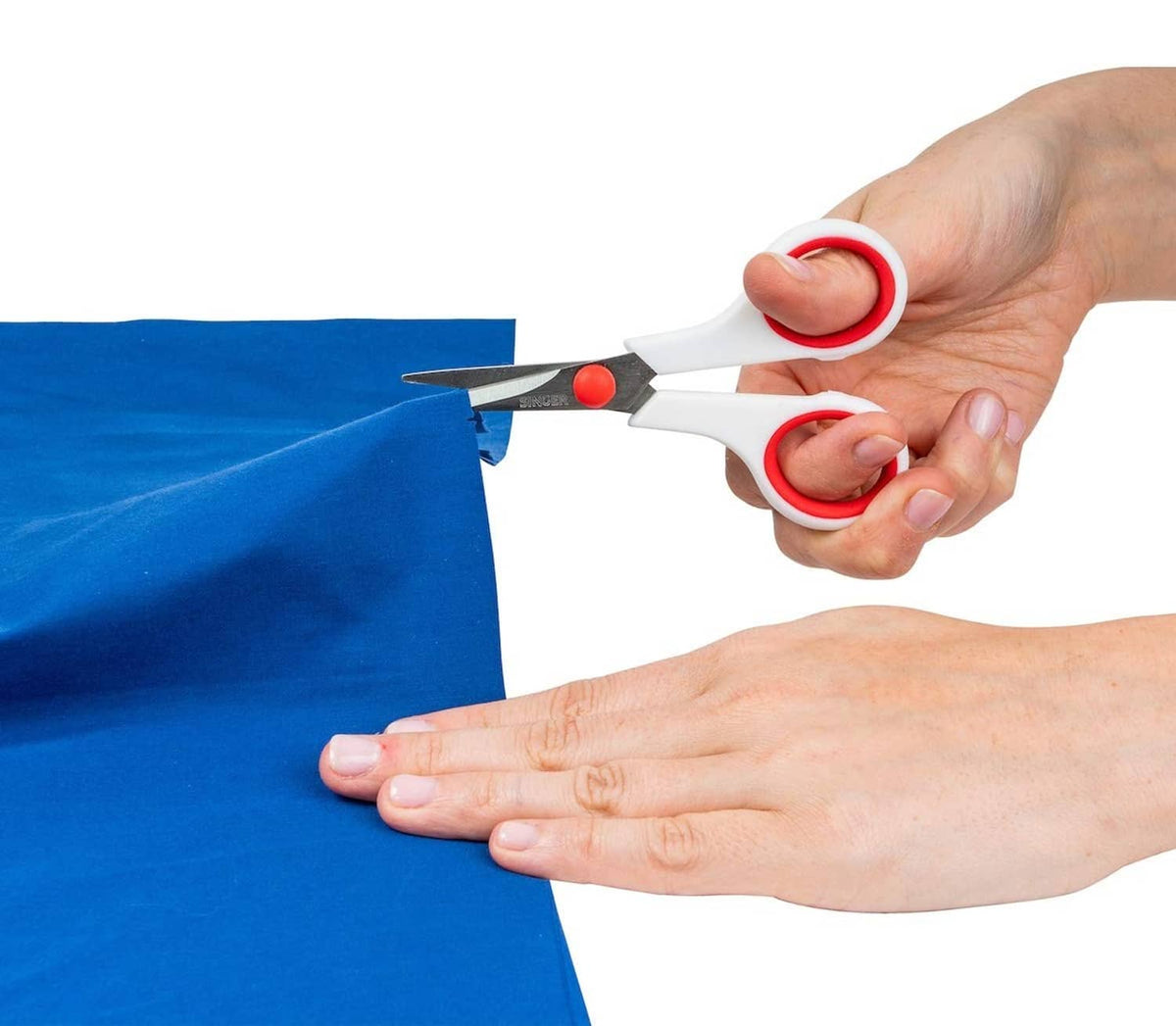 Hands using red-and-white Singer scissors to cut blue fabric