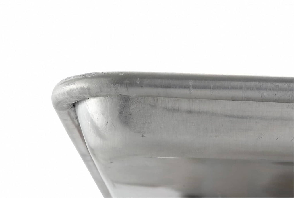 Silver sheet pan corner with rolled rim and smooth interior