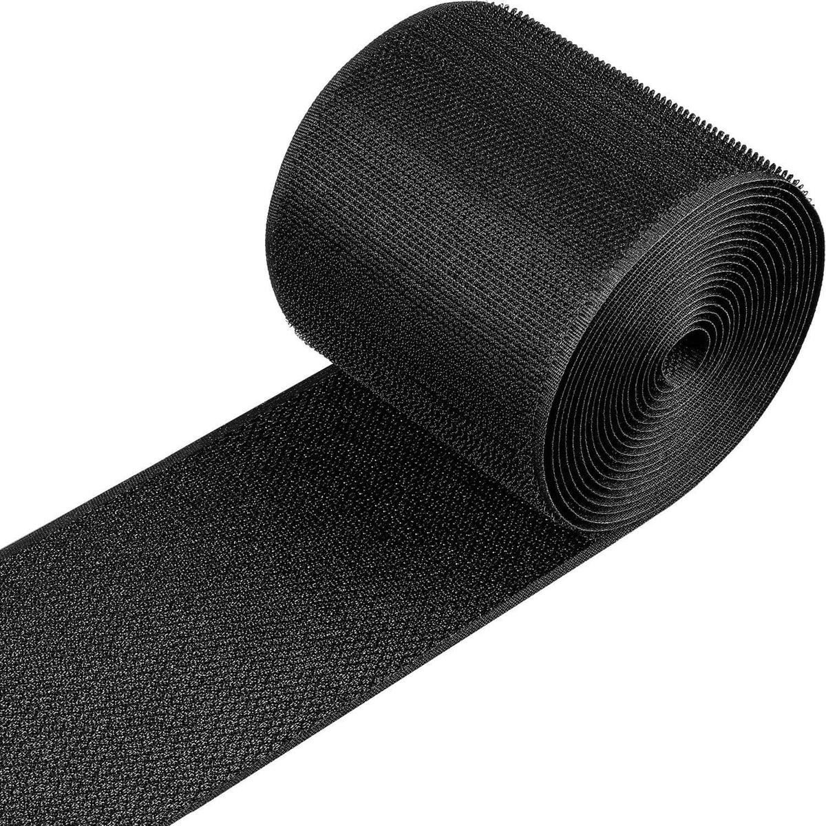 Black cable floor protection strip with textured grip surface, rolled for storage