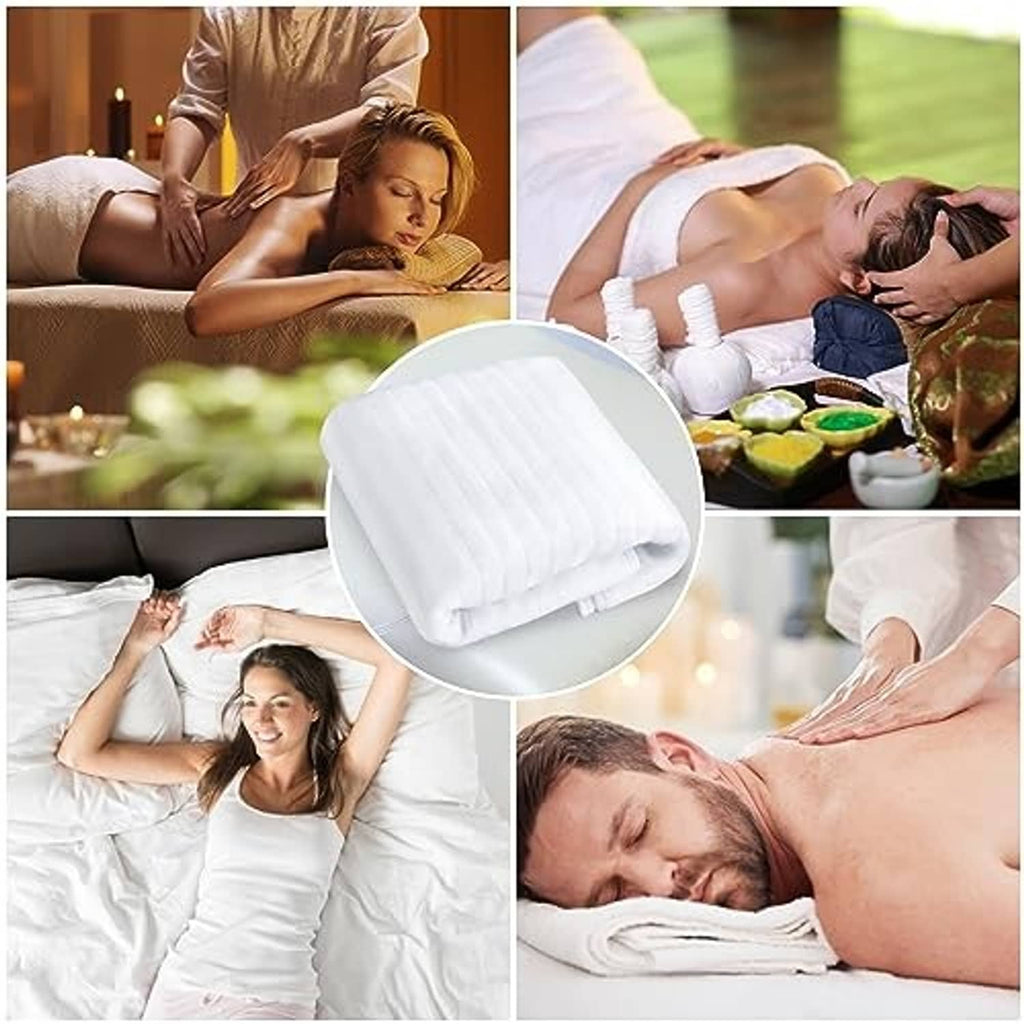 Folded electric massage table heating pad, white quilted pad shown in close-up