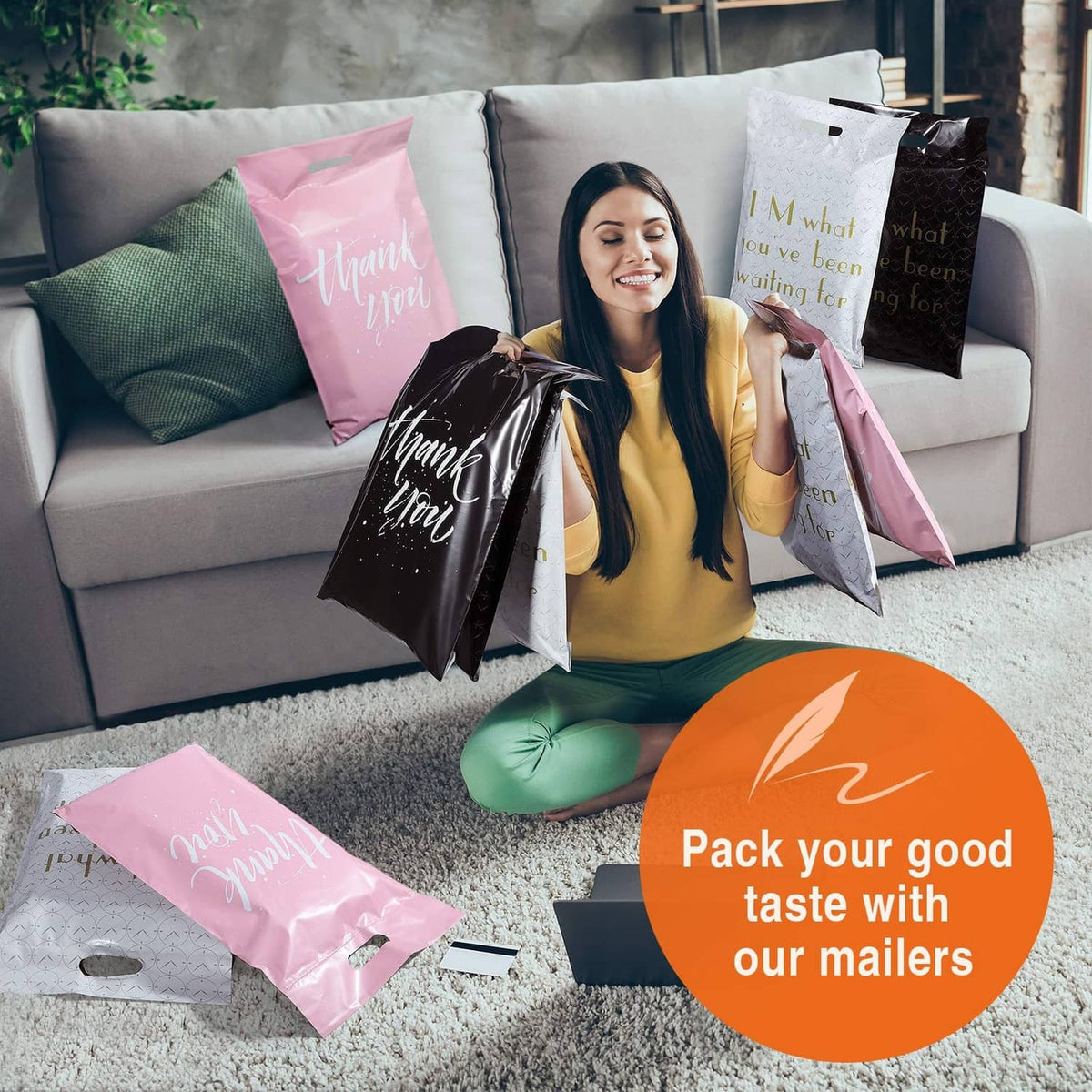 Pink and black poly mailers with “Thank you” prints on a living room couch