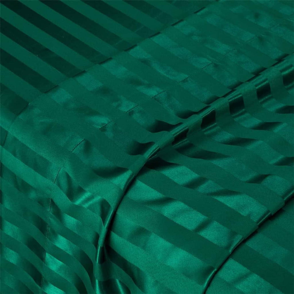 Teal green satin fabric close-up with crisscrossed folds and stripe texture