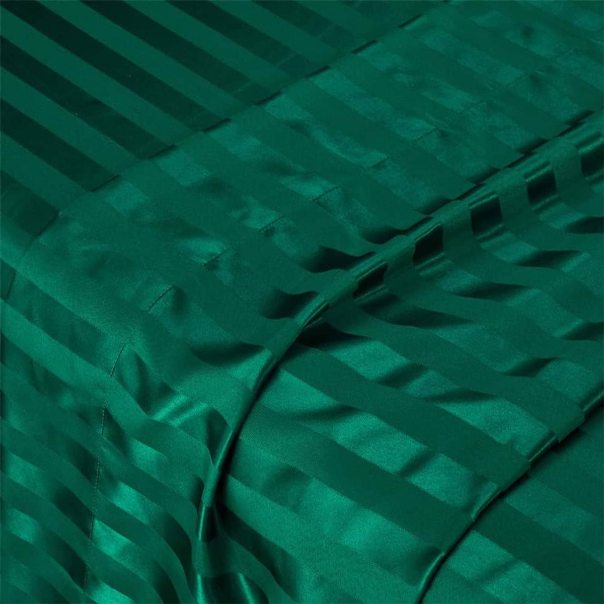 Teal green satin fabric close-up with crisscrossed folds and stripe texture