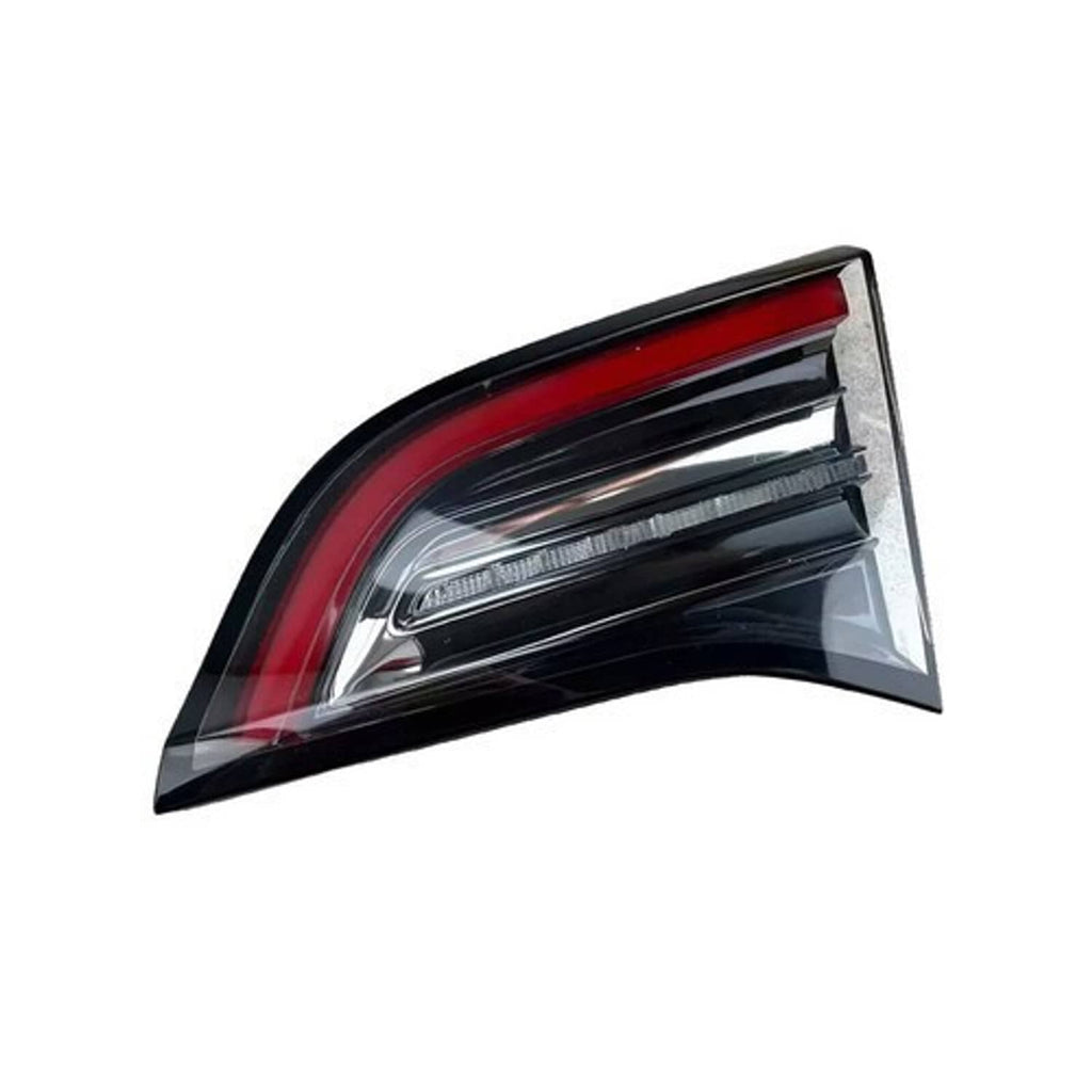 Right tail light with red reflector, clear lens, and chrome bar elements, dark trim.