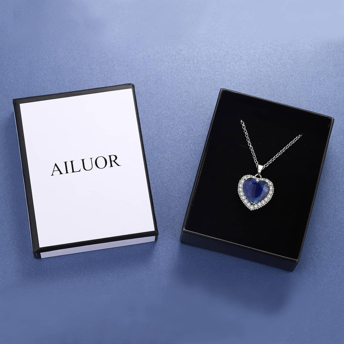 Heart blue gemstone pendant necklace displayed with gift boxes