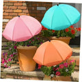 Three adjustable plant sunshade umbrellas in pink, teal, and orange on outdoor planters
