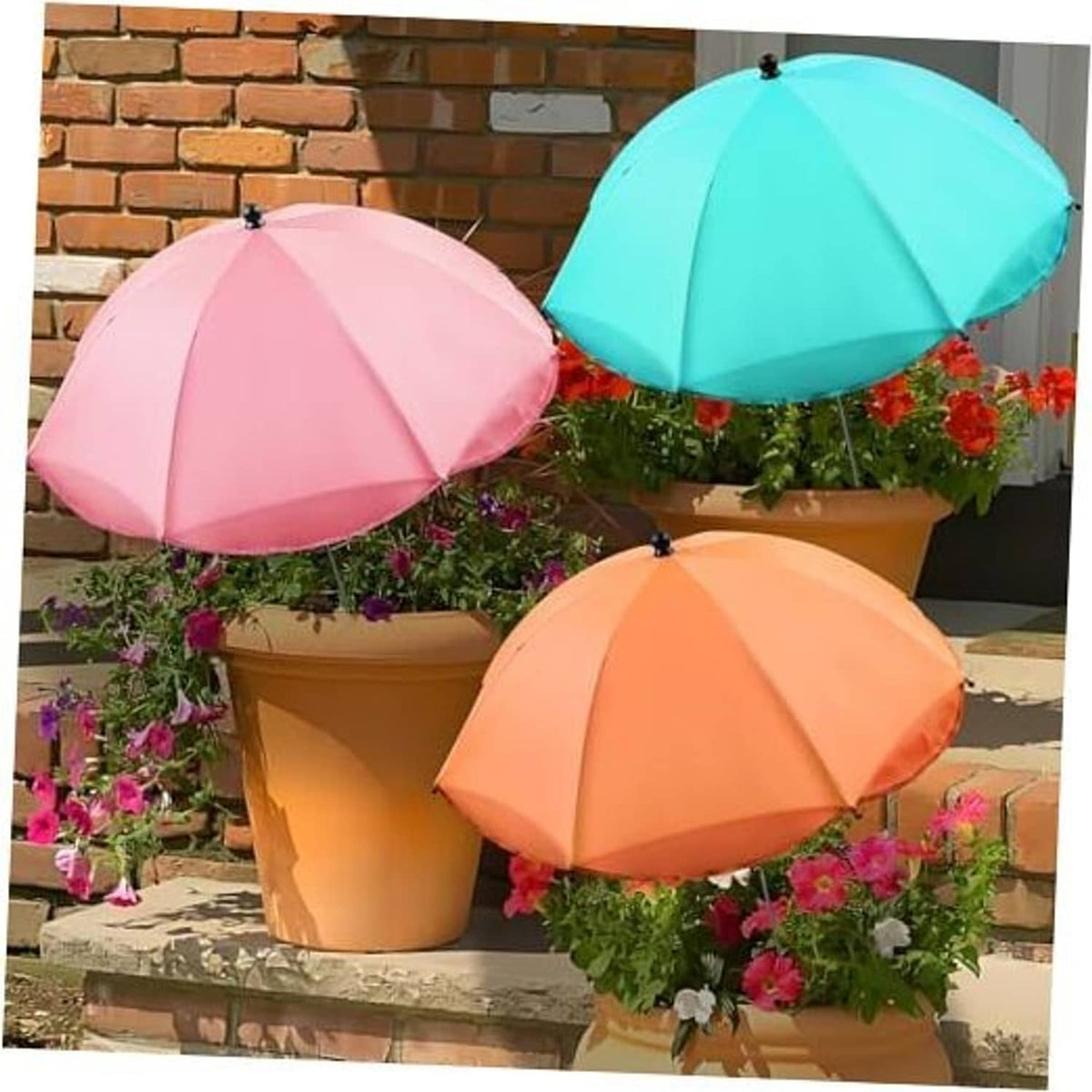 Three adjustable plant sunshade umbrellas in pink, teal, and orange on outdoor planters