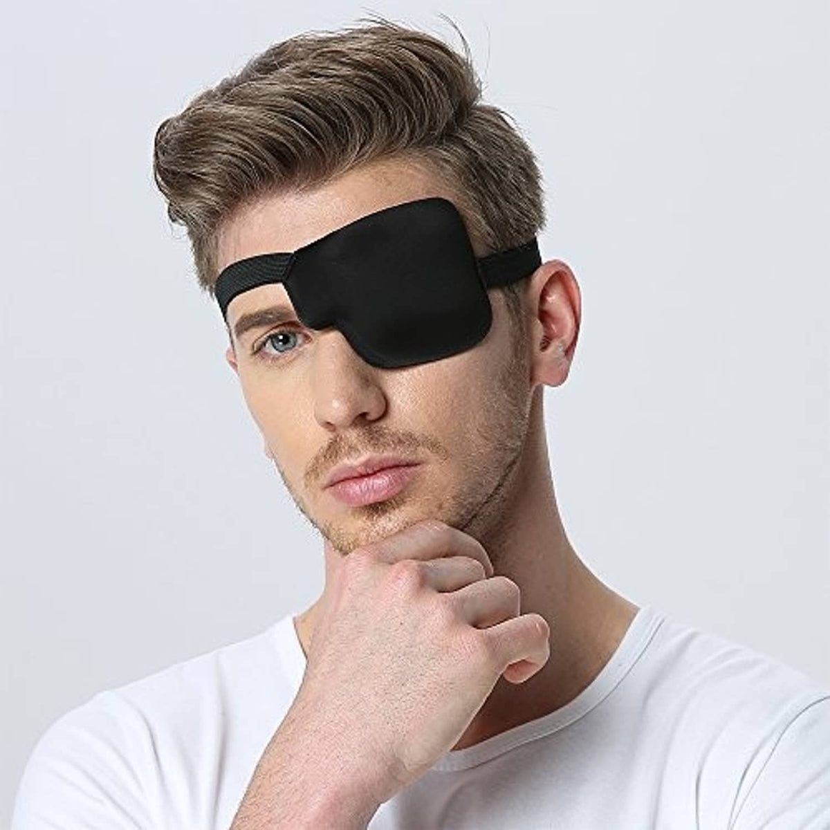 Black 3D contoured left eye patch on man, angled view with elastic strap