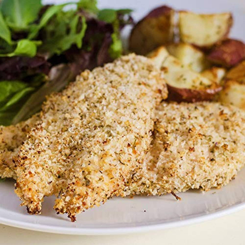Herb-crusted chicken cutlets with speckled Italian seasoning on white plate