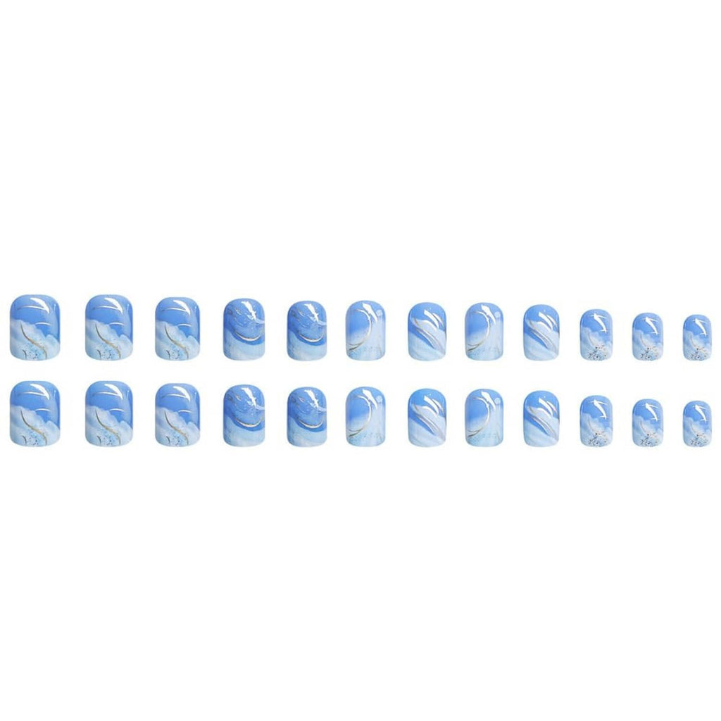 Row of short square press-on nail tips in blue gradient with white accent swirls