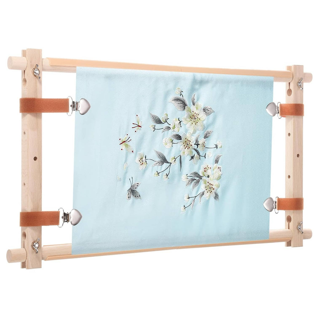 Wood needlepoint scroll frame holding light-blue floral embroidery fabric
