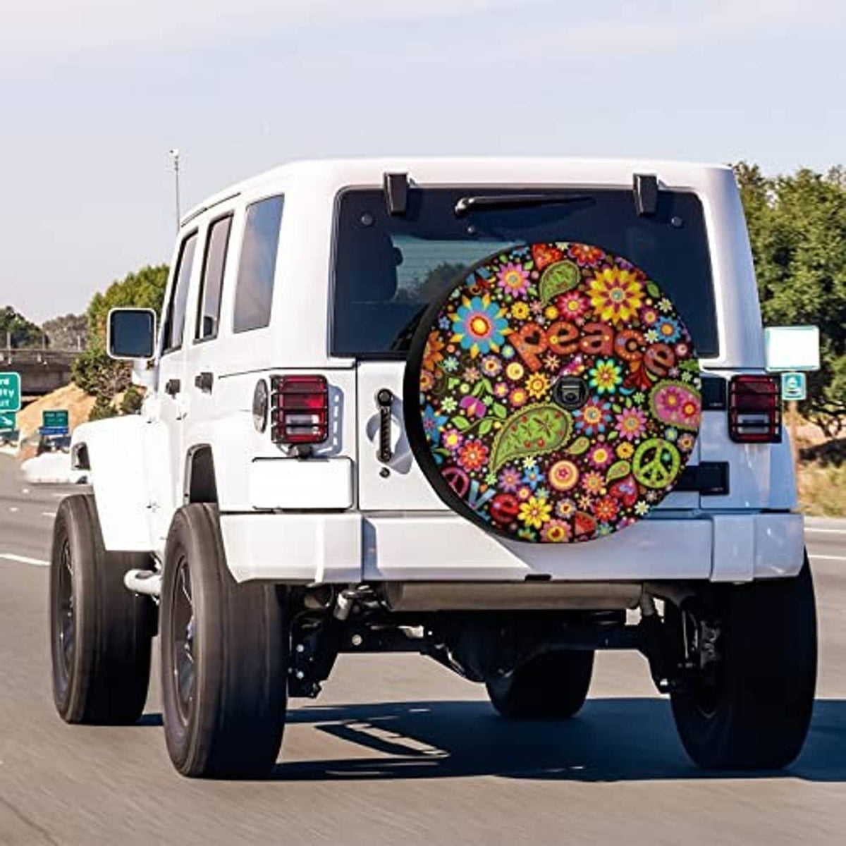 Spare tire cover with colorful floral peace design on a vehicle’s rear spare
