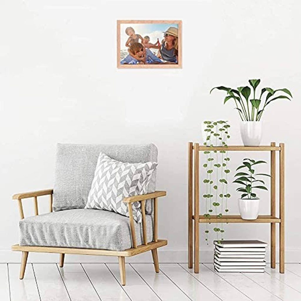 Natural oak wood 5x7 photo frame hanging on a wall above seating
