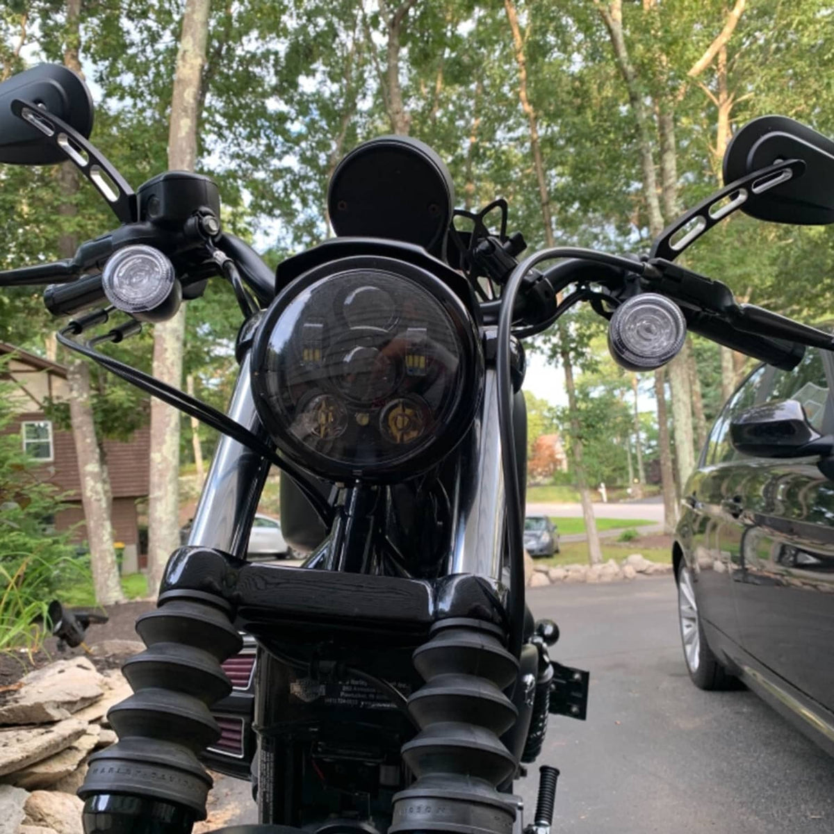 Pair of black rear-view mirrors on handlebars, oval housings
