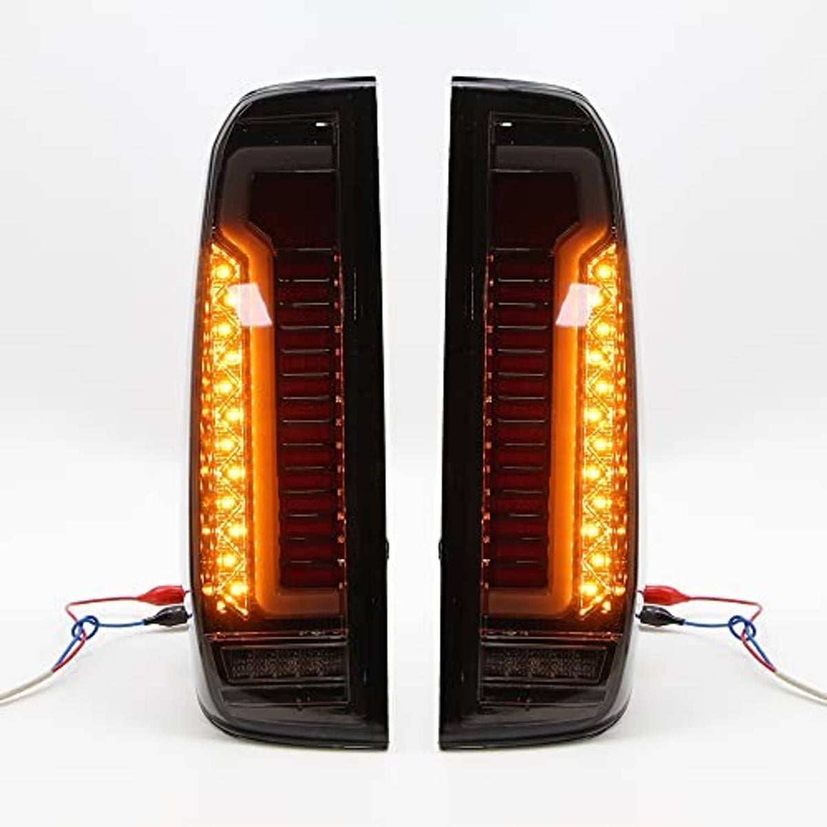 LED tail light assembly pair showing amber LED perimeter glow and red inner bars in black housings