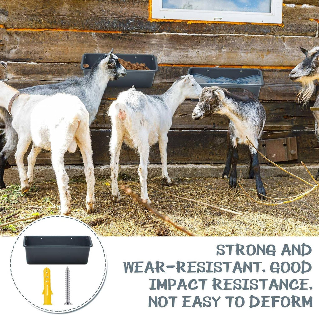 Dark gray feeder troughs in barn next to goats, on wall feeding area