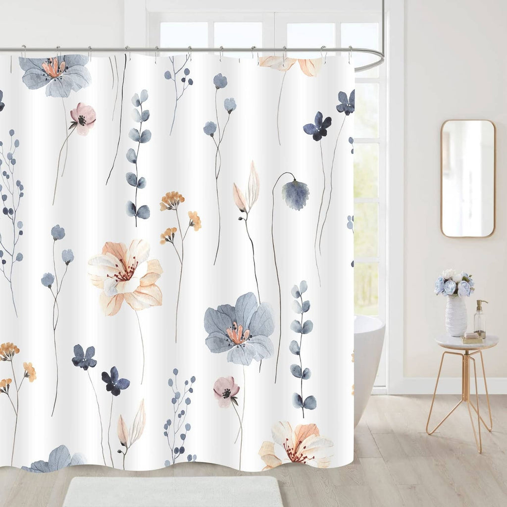 Floral shower curtain in blue and white, hung across a bathroom tub