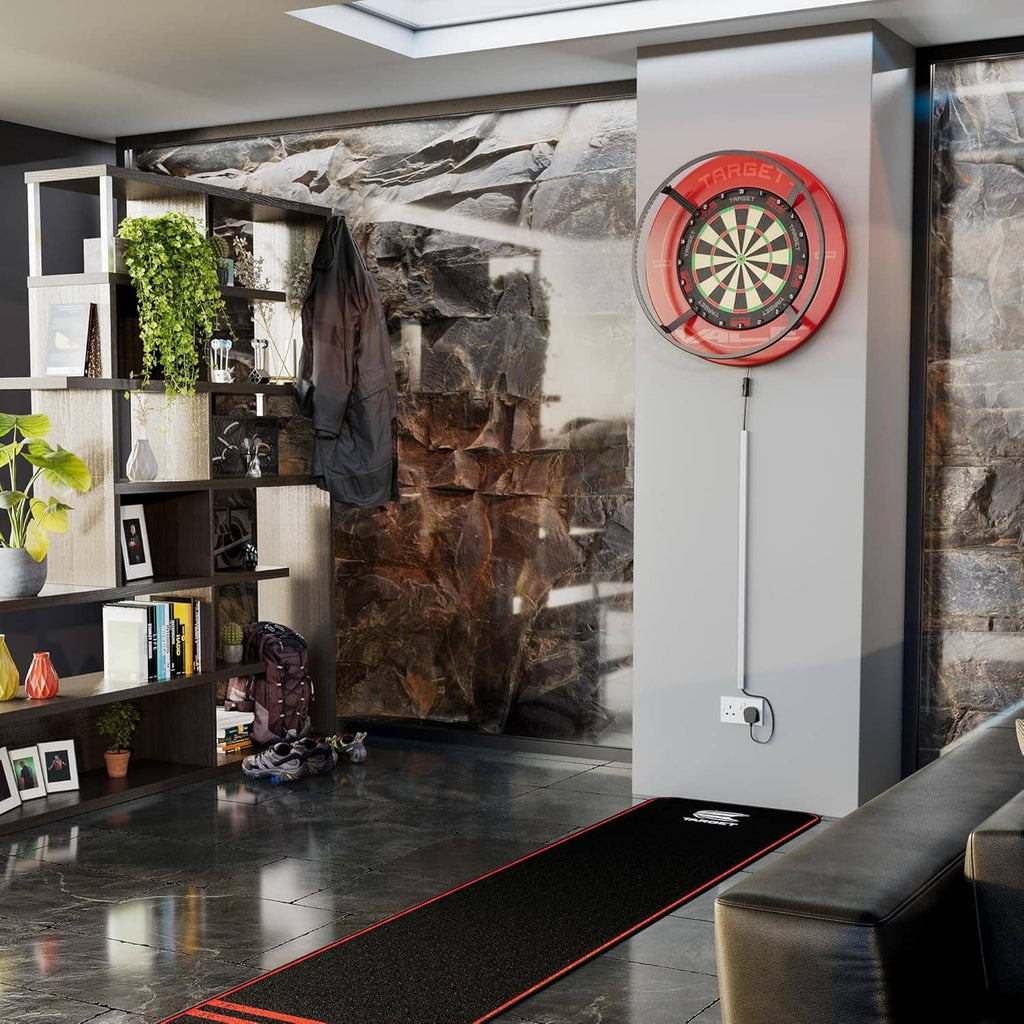 Dartboard lighting system mounted on a wall with red dartboard target and hanging power cord
