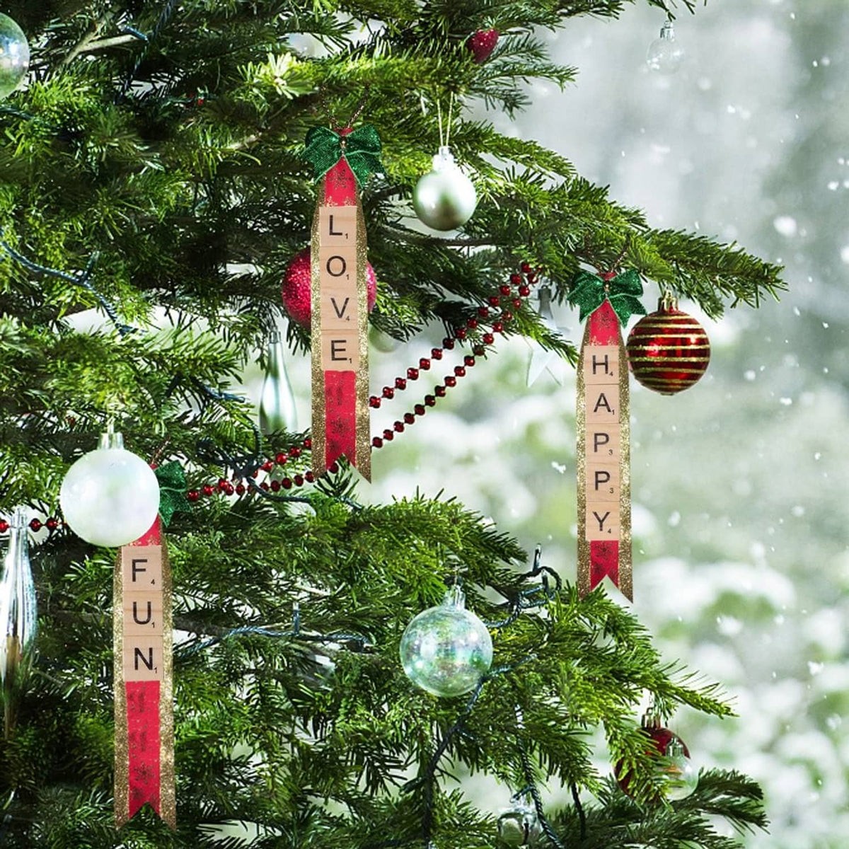 Wood letter tiles hanging on a Christmas tree, spelling “LOVE” and “HAPPY” vertically