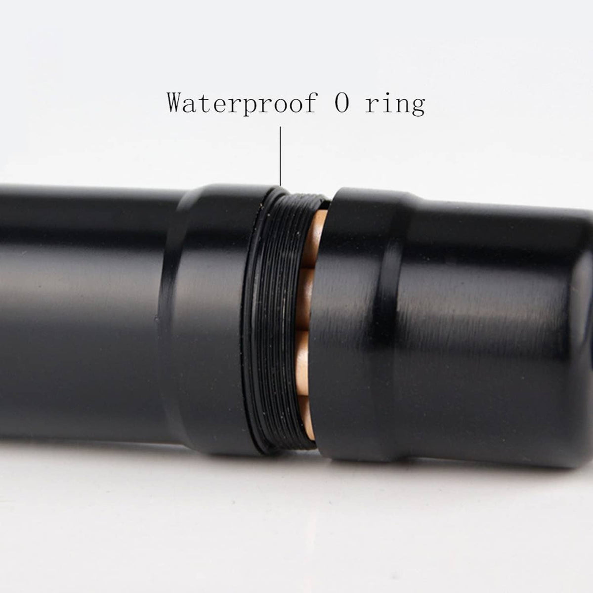 Close-up of black round cigarette case with textured grip ring and side seal