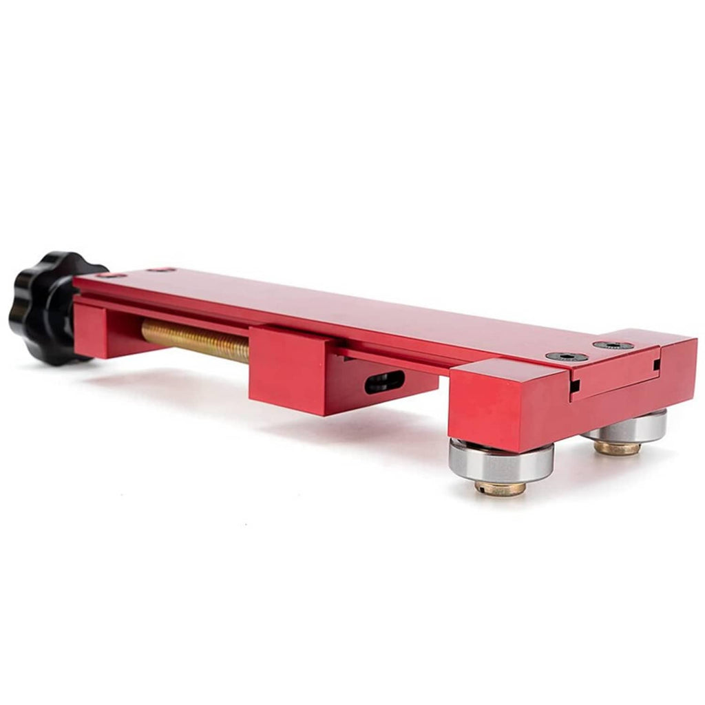 Red oil filter cutter tool side view with black knob, bearings, and threaded screw
