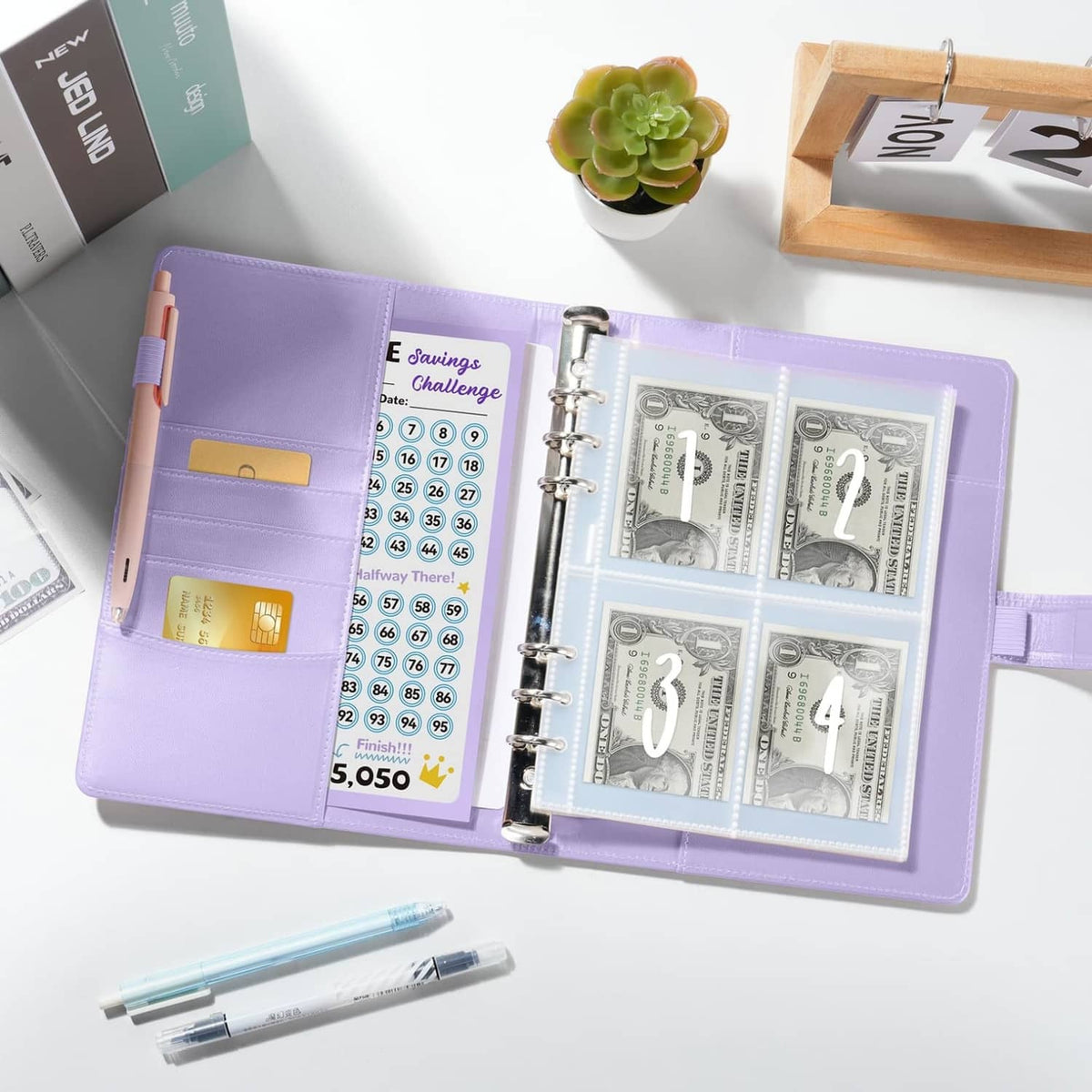 Open purple binder with six-ring binder and transparent money envelope slots
