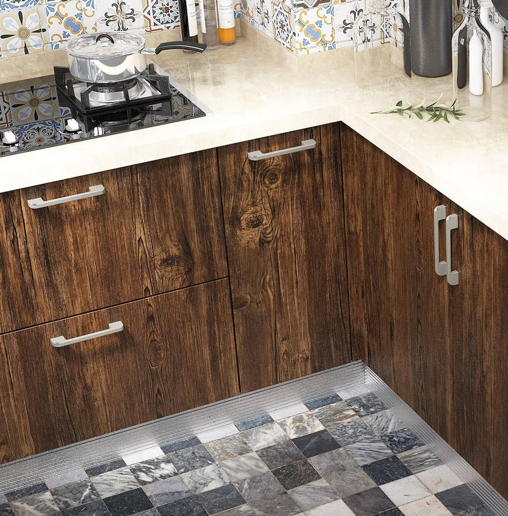 Brown faux wood contact paper on kitchen cabinet panels with plank seam lines