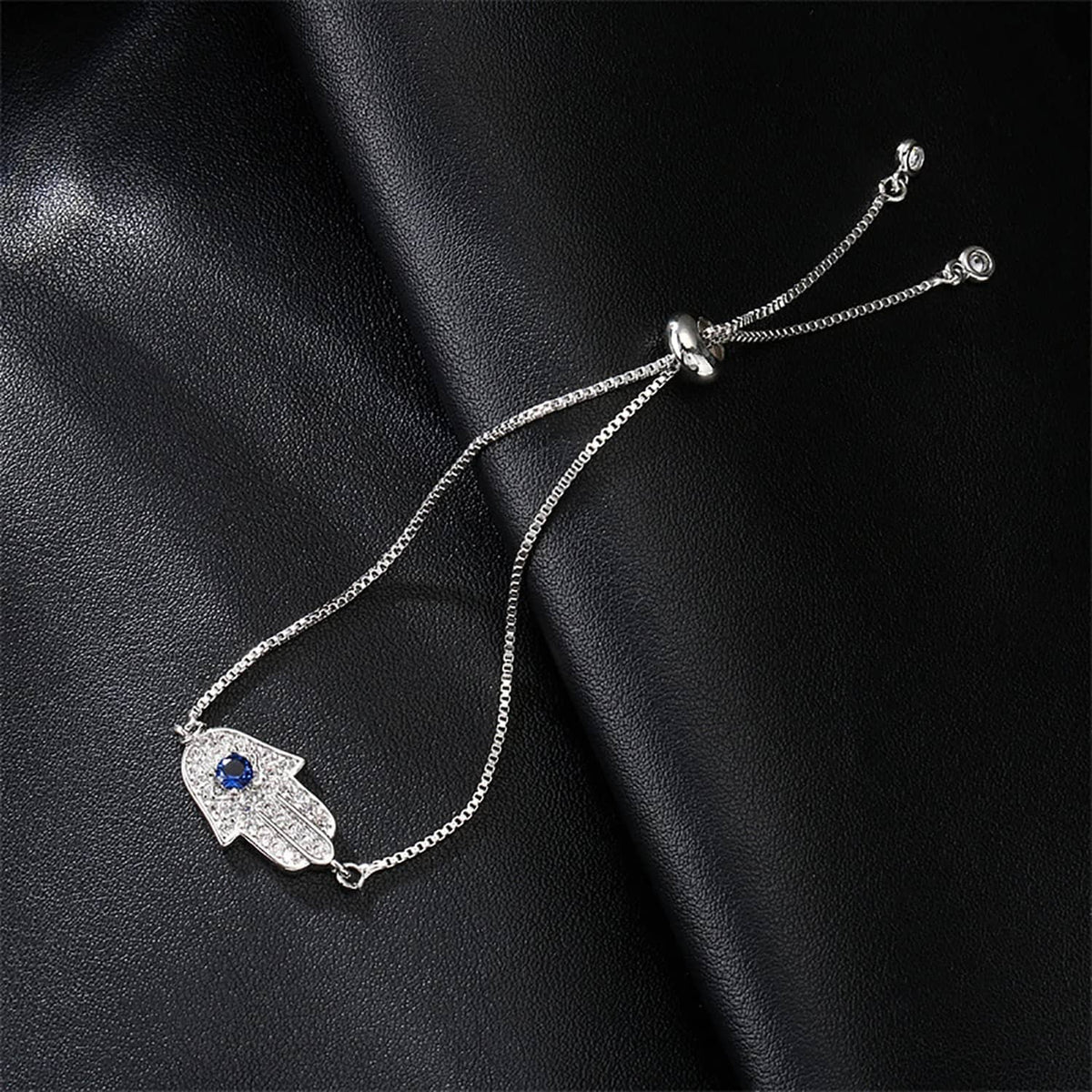 Silver hamsa charm bracelet with blue center stone and beaded side chains