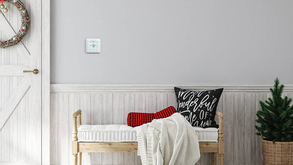 White wall-mounted Honeywell thermostat with small backlit touchscreen display