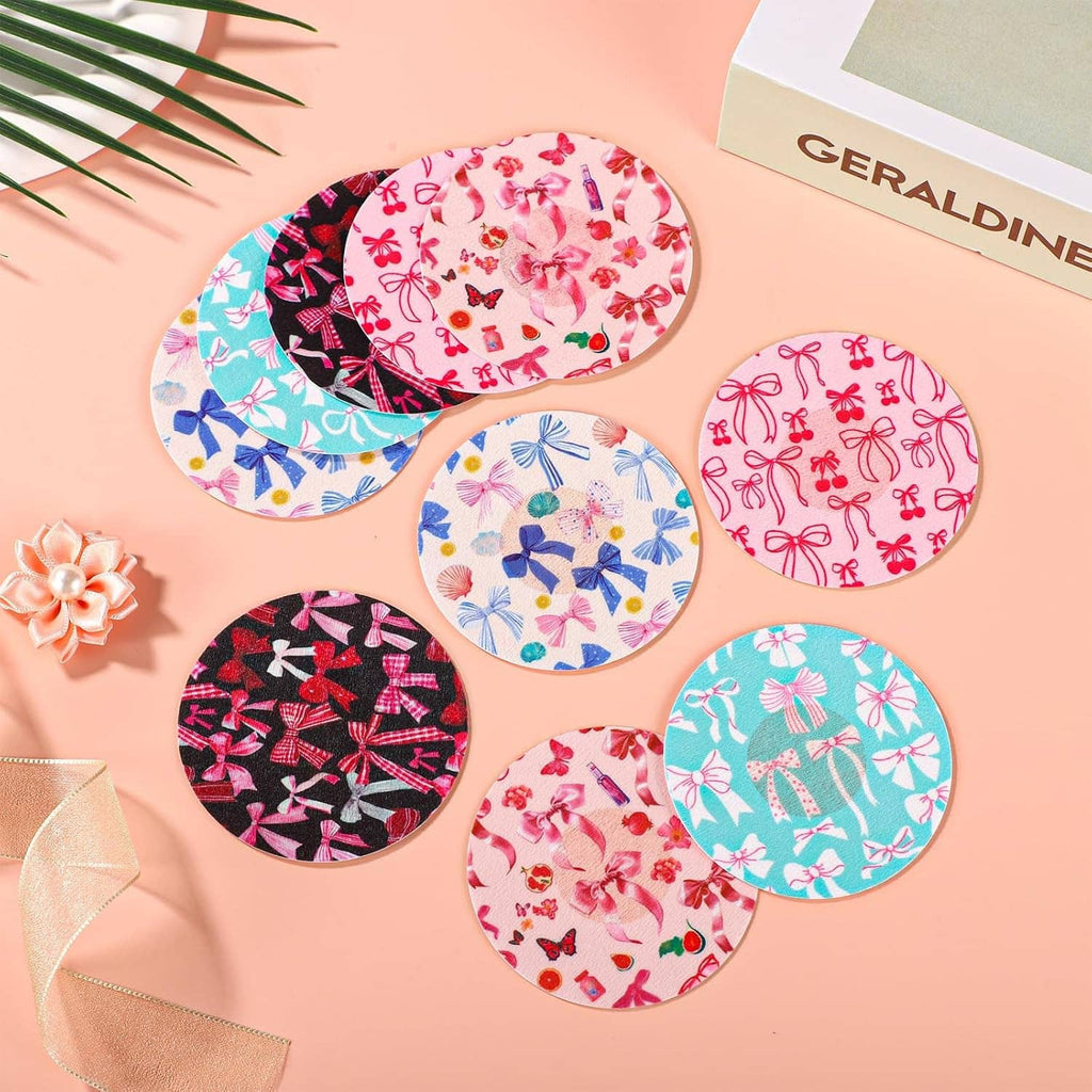 Assorted circular sensor patches with bow prints on a person’s arms