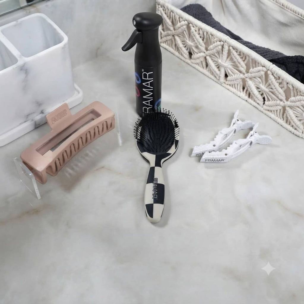 FRAMAR detangler hair brush with checkered accents, black oval bristle pad on countertop