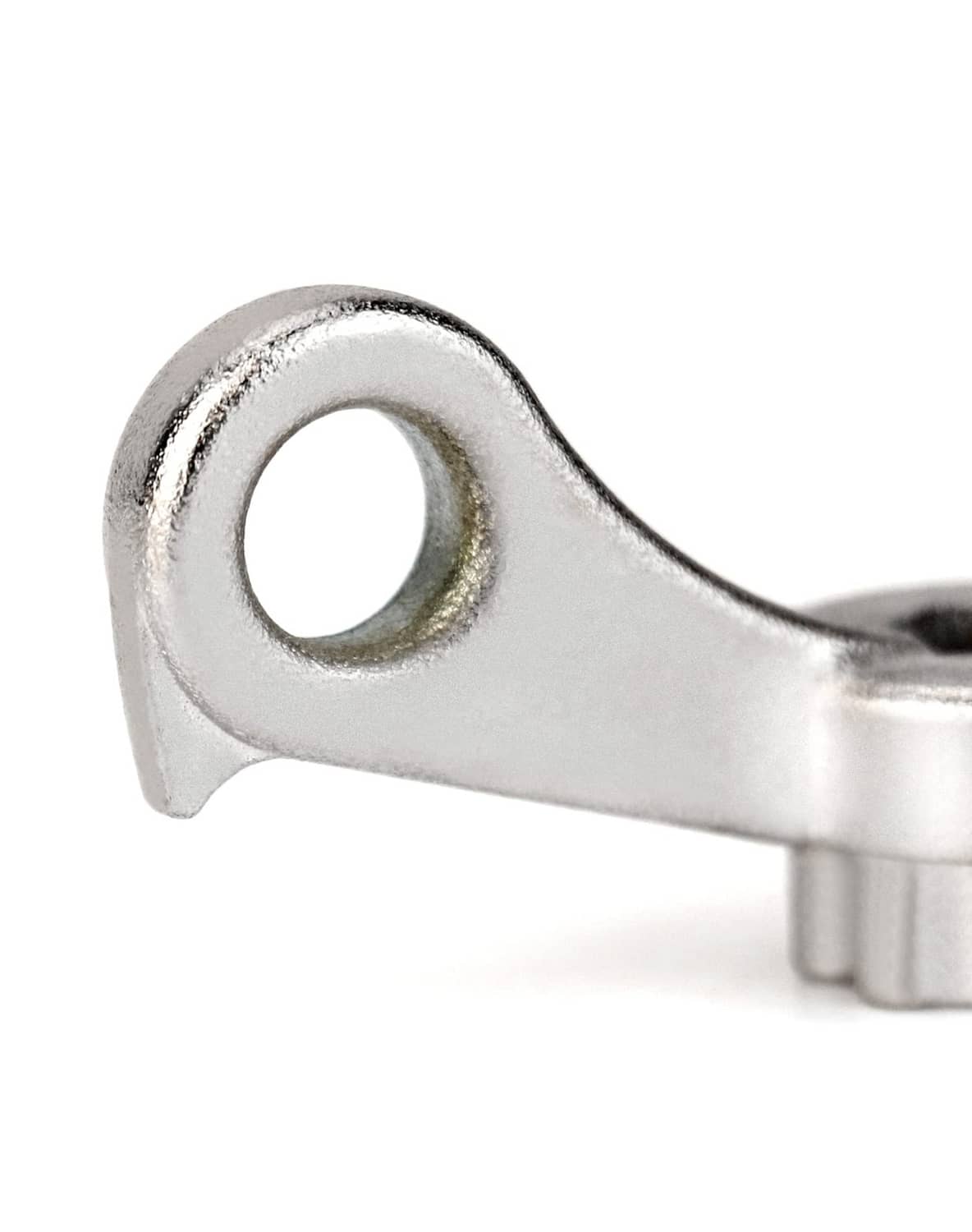 Silver ring-eye wrench tool close-up of round hole and curved shank