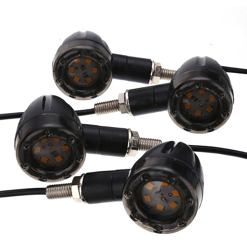 Four black motorcycle LED blinkers with visible orange diodes and threaded mounting posts