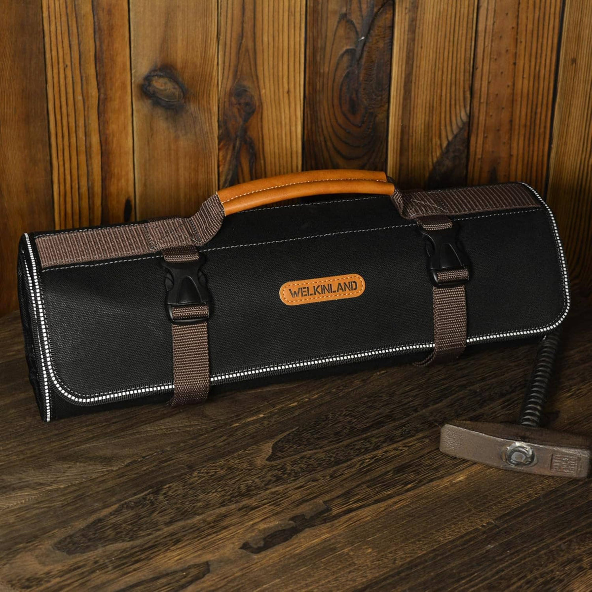 Welkinland black tool roll with brown straps and stitched trim, padded carry handle