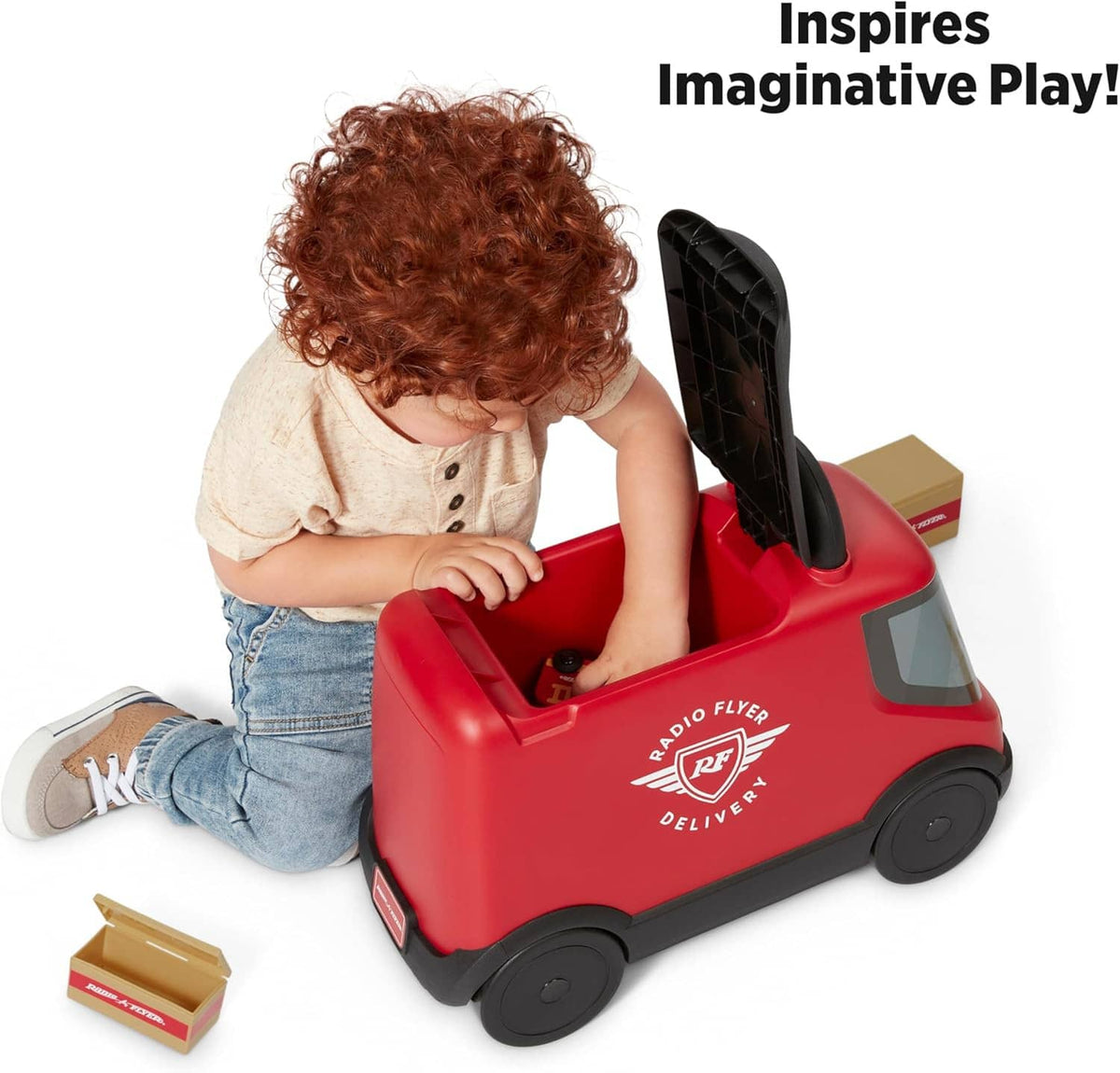 Red ride-on delivery truck toy with open storage and clear window; toddler playing