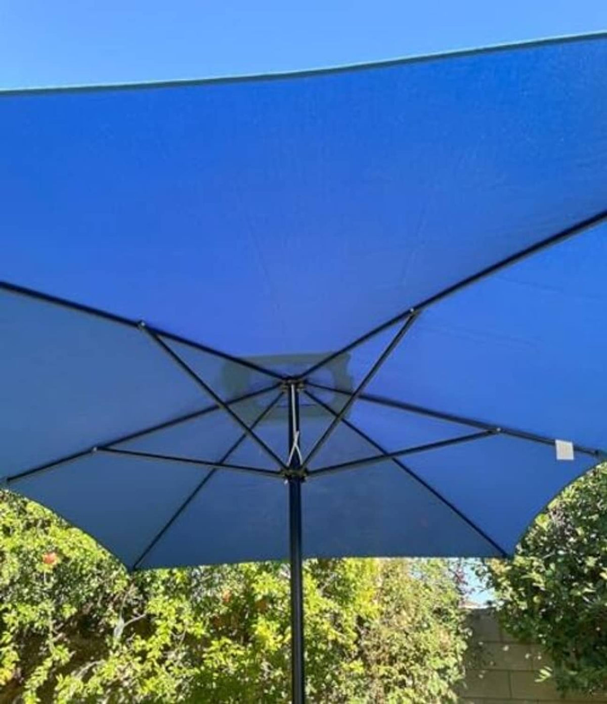 Blue umbrella canopy underside with black ribs and center hub, rectangular replacement cover.