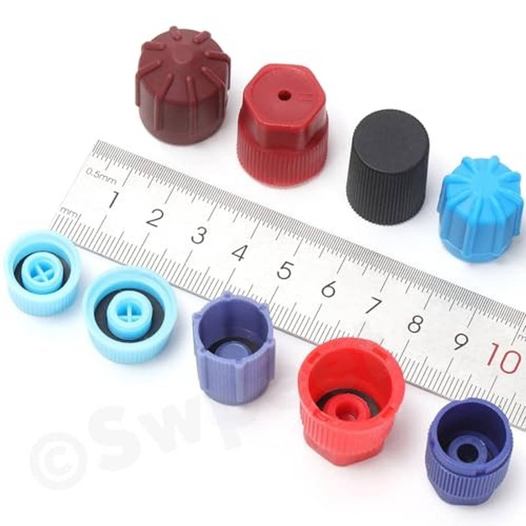 Colored A/C valve core caps with size guide on ruler: blue, red, purple, and black