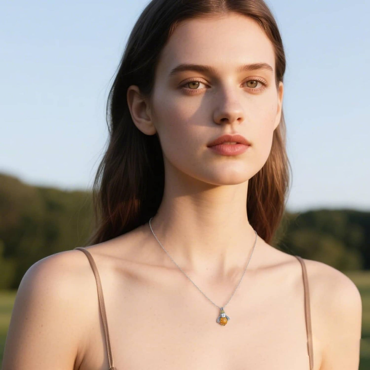 Sterling silver bee pendant necklace with amber crystal center on slim chain