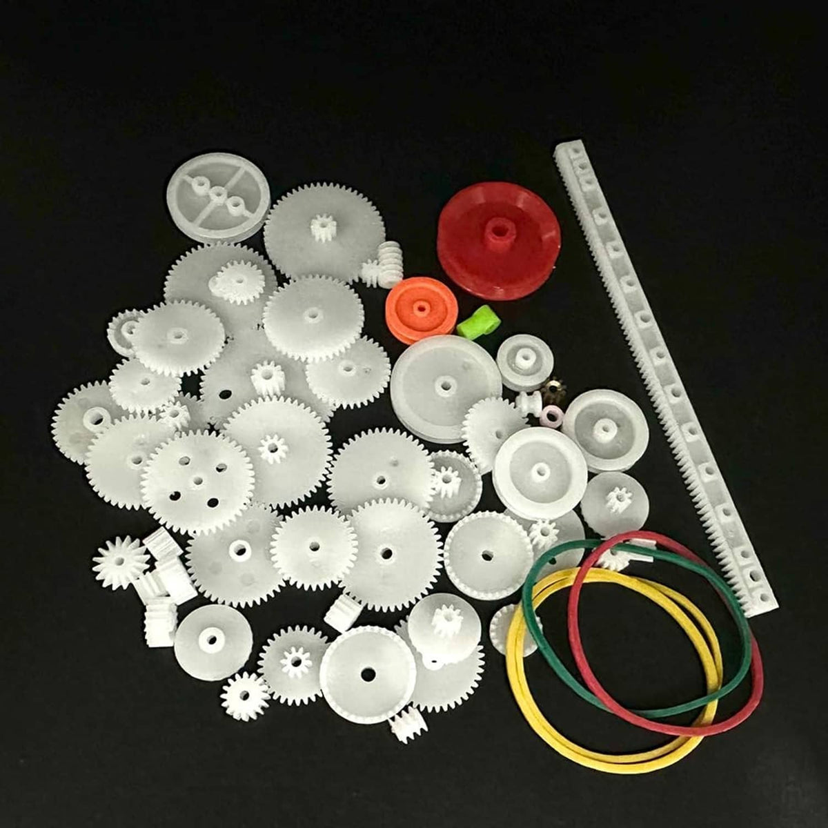 Plastic gear kit with white gears, large red pulley, and green belt and bands