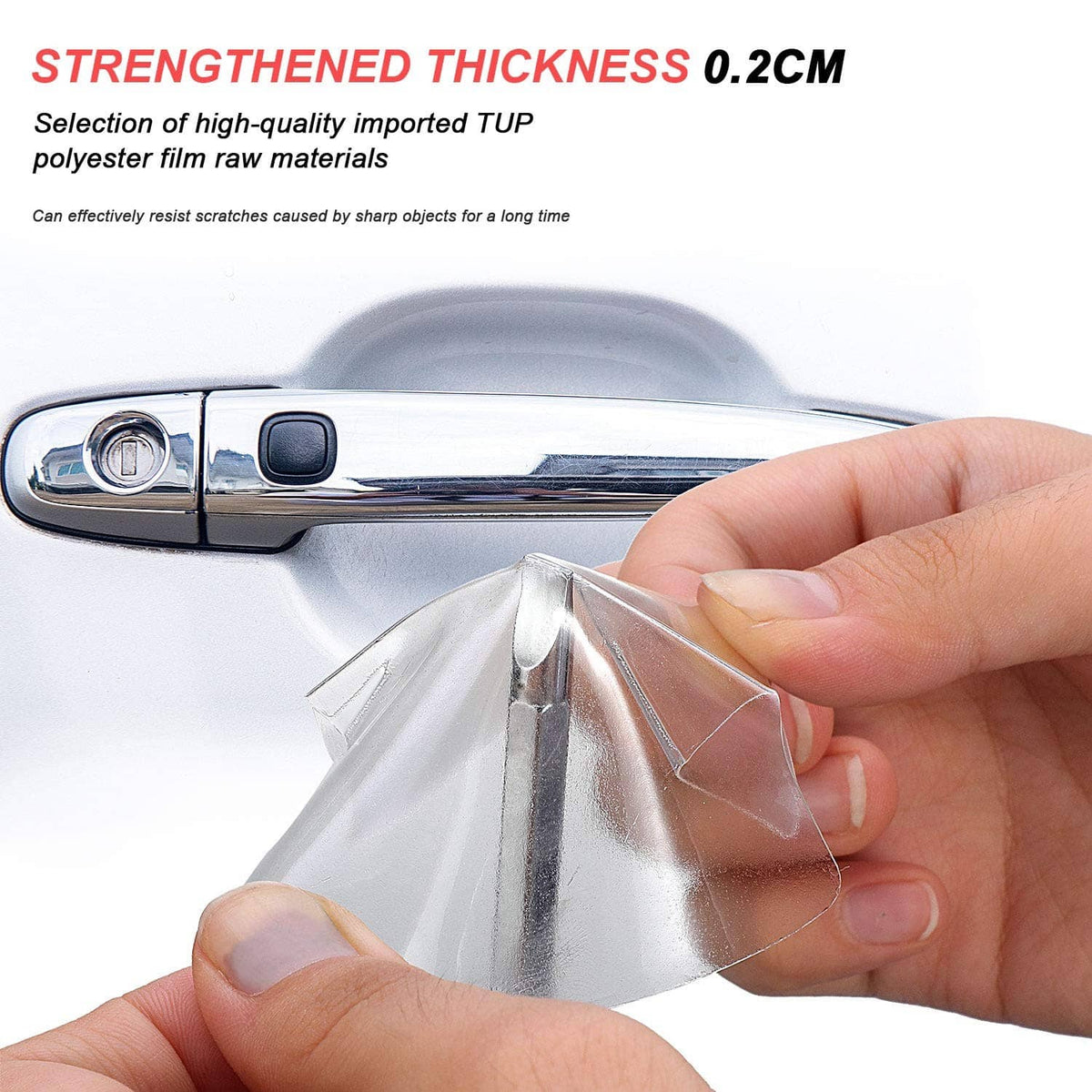 Hand applying clear car door handle cup protector film to a chrome handle