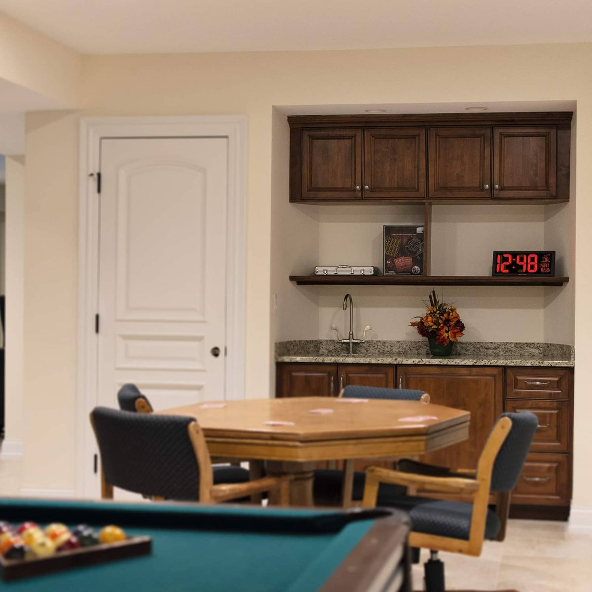 Acurite digital clock with red LED display, resting on kitchen countertop