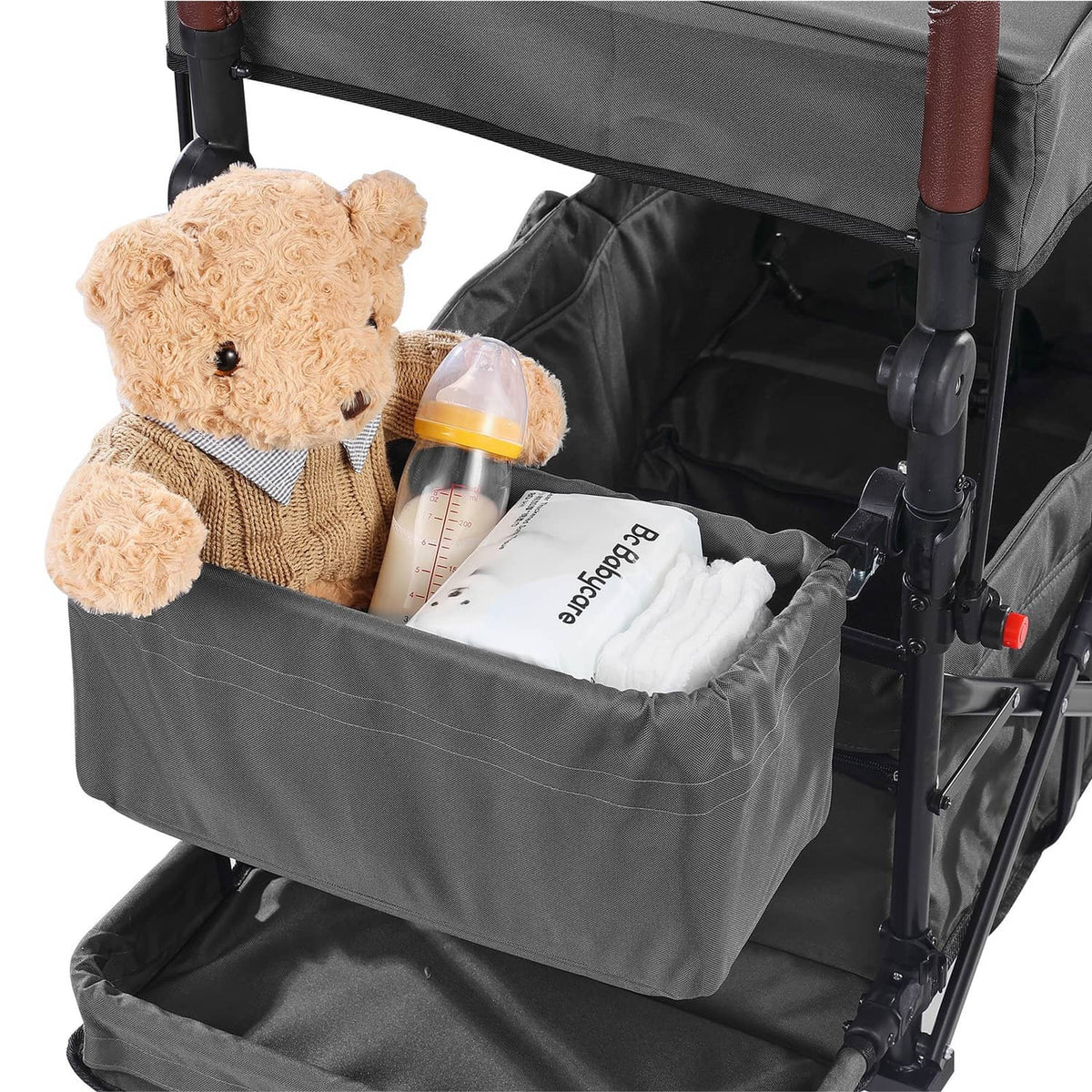 Dark gray double wagon stroller with canopy, front basket holding baby essentials