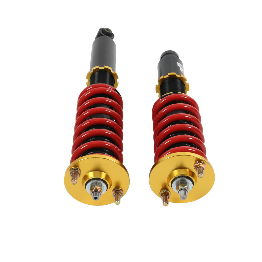 Top view of two coilover shocks with red springs and gold mounting plates
